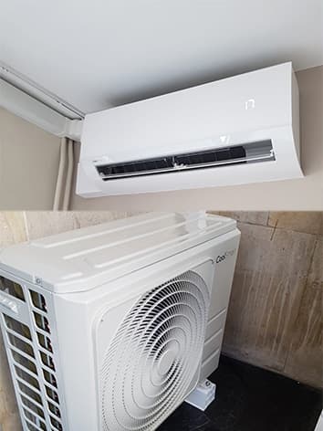 photo d'un climatiseur coolsmart blanc accroché au mur avec son moteur en bas