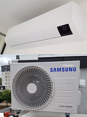 photo d'un climatiseur samsung blanc accroché au mur avec son moteur en bas
